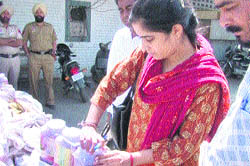 A health department official checks a jar of pickle at Fatehgarh Sahib