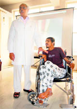 Orthopaedic surgeon Dr BKS Sanjay with a patient in Dehradun on Thursday.