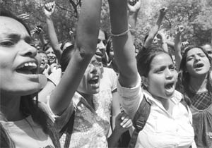Thousands of people including school children, teachers, social workers and bank officials shout anti-corruption slogans in support of veteran Indian social activist Anna Hazare during his fast unto death against corruption in New Delhi on Friday.