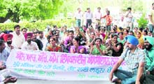 NRHM employees stage a protest outside the office of the DC in Ludhiana on Friday.