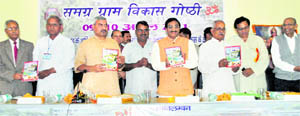 Uttarakhand Chief Minister Ramesh Pokhriyal Nishank releases a souvenir at a workshop on village development at Doon University on Saturday