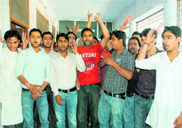 ABVP activists stage a protest at the local office of HNB Garhwal University in Dehradun on Friday