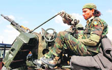 A rebel rests on his vehicle near Brega. 