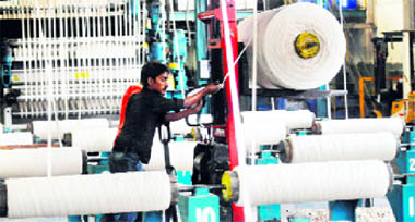 This picture shows an employee working in a textile factory in the Pakistan's port city of Karachi.