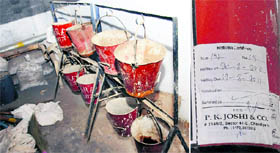 Empty buckets of sand placed in the corridor of Government High School; and (right) fire extinguishers installed at Government Senior Secondary School, Ramdarbar, have not been refilled. These had to be filled two months ago.