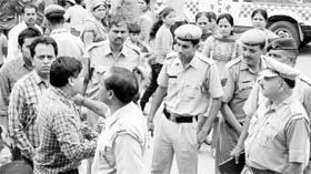 Panchkula tehsildar Satish Singla (side profile) argues with police officials near the VVIP gate after he was prevented from entering the Mata Mansa Devi Shrine complex on Sunday.