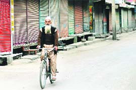 lone ranger: An elderly rides a bicycle