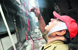 A fireman struggles to douse flames