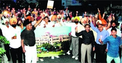 Khalsa College teachers and Cot Khalsa land donors conduct a candlelight vigil in Amritsar on Sunday.
