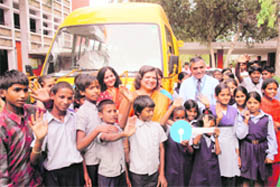 Students of Government Model School, Sector 8, all smiles after receiving keys of a school bus given by the State Bank of India, Chandigarh, on Monday.
