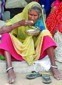 A Bhopal gas tragedy victim takes lunch at a dharna at Jantar Mantar in New Delhi