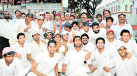 Teams of Graphic Era (A) and the Institute of Technology Management pose with the trophy of the 59th District Cricket League after the final ended in a tie in Dehradun on Monday.