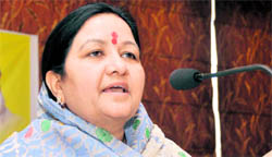 Mangala Devi, wife of Bholeji Maharaj, addresses the media in Dehradun on Monday.