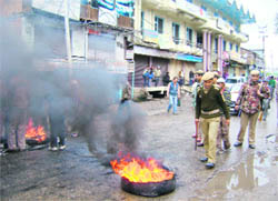 Protesters burn tyres during a bandh in Kishtwar on Monday called against the killing of Moulana Showkat Shah.