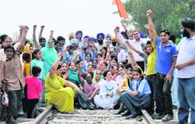 Residents of several localities in Ludhiana squat on the railway track of the Ludhiana-Ferozepur section to press their demand for an alternative level crossing on Monday
