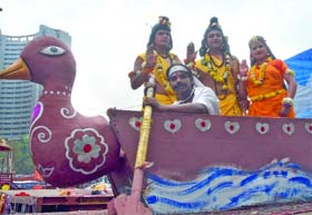 Devotees dressed as Lord Rama, Lakshmana and Sita take part in a religious procession held on the occasion of Ram Navami at Ramlila Maidan in New Delhi on Tuesday