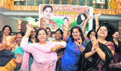 Women Congress workers dance at a Baisakhi function in Dehradun