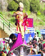 A child attired as Lord Krishna during a religious procession in Shimla