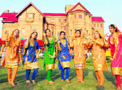 Girls perform during the Baisakhi Mela at Hari Niwas in Jammu on Tuesday