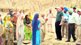 Deputy Commissioner Yashvir Mahajan enquires about the scheme from residents of Khant village.
