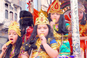 Children have ice candy during the Ramnavami shobha yatra in Jalandhar on Tuesday.