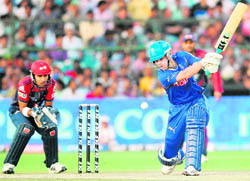Rajasthan Royals Johan Botha plays a shot as Delhi Daredevils wicket keeper Naman Ojha (L) looks on in Jaipur on Tuesday