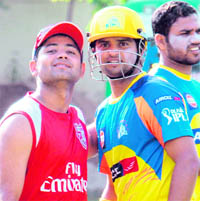 Piyush Chawla (left) of Kings XI and Suresh Raina of Chennai Super Kings at the PCA stadium in Mohali on Tuesday
