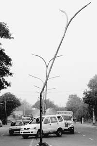 A bent traffic light pole on the road separating Sectors 12 and 12-A poses a risk to the lives of commuters in Panchkula