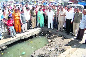 Dehradun Mayor Vinod Chamoli inspects a waterlogged drain in Dehradun on Wednesday