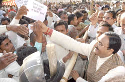 Chief Minister Ramesh Pokhriyal Nishank breaks a security cordon to meet common people as part of his Vikas Yatra in Roorkee
