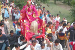 A man, who is considered a local deity during the festival, being taken in a palanquin in Pitthoragarh.