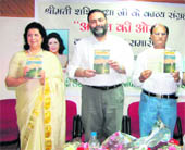 Vice-Chancellor of the University of Jammu, Prof Varun Sahni (centre), releases a book of Hindi poems Anant Ki Aur in Jammu on Wednesday. 