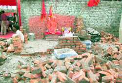 The demolished boundary wall and a pedestal to keep idols at Transport Nagar in Ludhiana