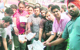 Bhartiya Janata Yuva Morcha workers burn copies of the Congress mouthpiece in protest against publication of remarks on martyrs in Ludhiana on Wednesday
