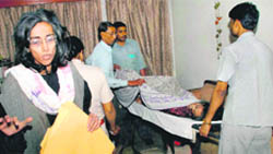 Two sisters who had shut themselves up in their house for seven months being taken to a hospital.
