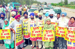 Victims of the 1984 riots block the national highway at Rajpura on Wednesday