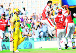 Kings Xi Punjabs Praveen Kumar celebrates the wicket of Chennai Super Kings Suresh Raina at the PCA Stadium in Mohali on Wednesday
