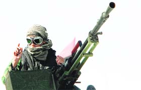 A Libyan rebel with a heavy machinegun, near Ajdabiya on Wednesday