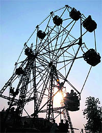 People enjoy a ride on a big wheel during a Baisakhi mela in Karnal on Thursday.