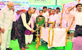 Chief Minister Prem Kumar Dhumal lights a lamp at a function on Dr Ambedkars birth anniversary at Hamirpur on Thursday