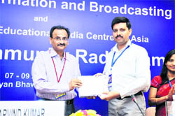 Director of CDLU radio station Virender Chauhan gets an award from Arvind Kumar, Joint Secretary, Union Information and Broadcasting Ministry, in Delhi.