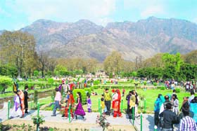 Tourists and locals enjoy at the Mughal Gardens after it was thrown open to public on the occasion of Baisakhi in Srinagar on Thursday