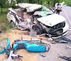 A car while trying to overtake banged into another speeding car coming from the opposite side. Two persons were killed and three were injured in this major accident on April 11, 2011