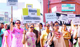 Teachers hold a protest against the proposed move to convert Khalsa College into a private university, in Amritsar on Thursday