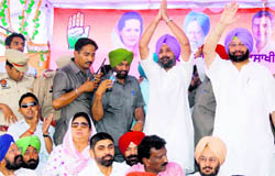 PPCC president Capt Amarinder Singh and his son Raninder Singh wave to the crowd during a conference in Talwandi Sabo on Thursday. Also seen in the picture are Rajinder Kaur Bhattal and Lal Singh