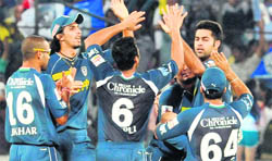 Deccan Chargers players celebrate the fall of a wicket in Hyderabad