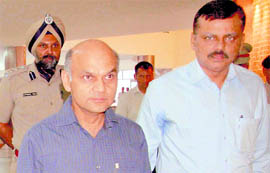 New Adviser to the UT Administrator KK Sharma, accompanied by Finance Secretary VK Singh and UT SSP Naunihal Singh, walks to his office to take charge at the UT Secretariat, Chandigarh, on Friday.