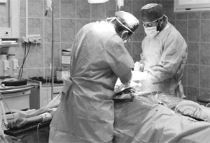 Doctors operate on a rebel fighter, seriously injured by Gaddafi forces near the front-line, in a Ajdabiyah hospital on April 14, 2011.