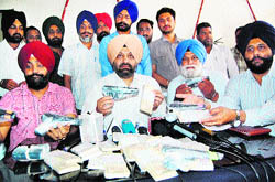 Officials of the State Special Operation Cell show fake currency and arms seized in Amritsar on Friday
