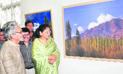 Veteran artist Triloke Kaul (extreme left) and First Lady Usha Vohra at her photo exhibition in Jammu on Friday.